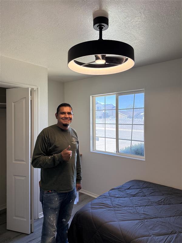 Pascual Lozano, owner of Lozano's Handyman Services LLC, giving a thumbs up after installing a ceiling fan